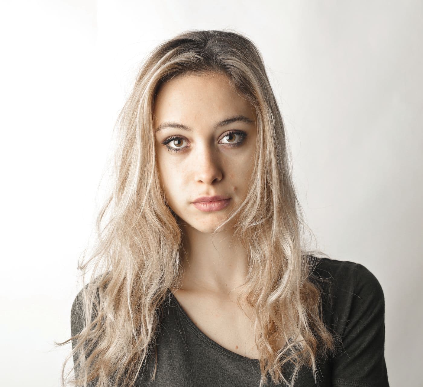 Person with clear, natural skin against a light background
